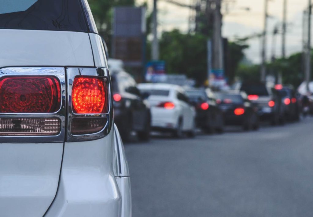Vehicle driving efficiently on New Zealand highway demonstrating smooth driving for better fuel economy.
